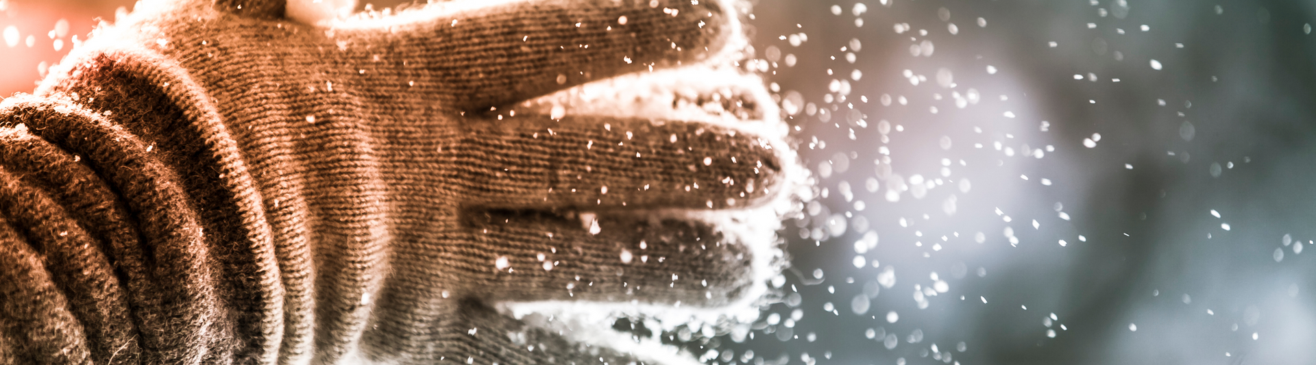 Person's hands wearing gloves in cold winter air