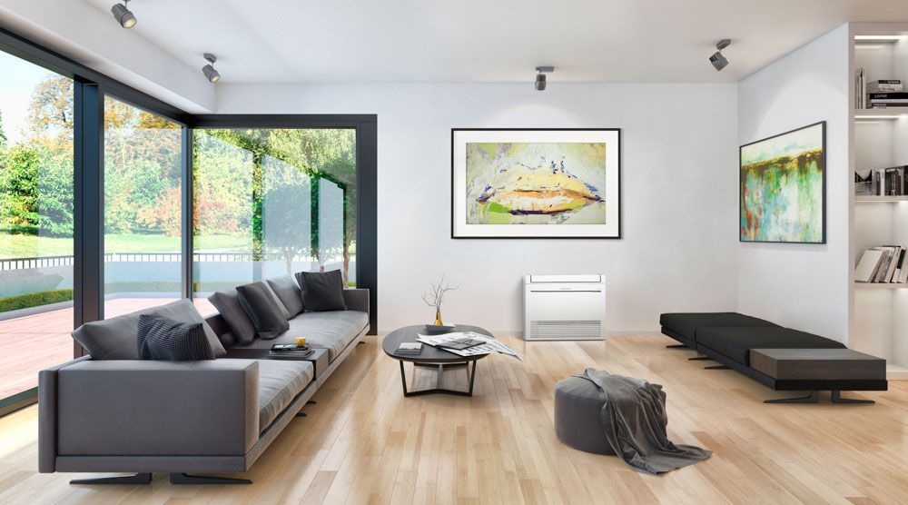 Mitsubishi Electric floor console heat pump in modern living room with large windows.