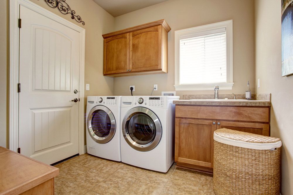 A Laundry Room With a Washer and Dryer and a Sink — Bradmark Appliance Service in Garbutt, QLD