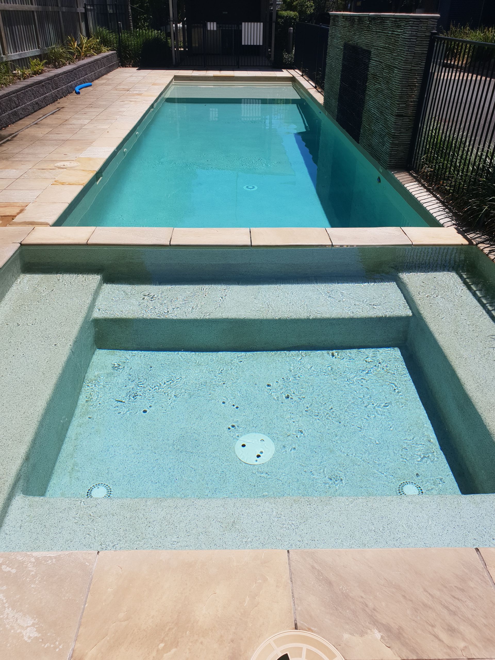 Two Men Are Working On A Swimming Pool — Kingscliff Pool Shop In Casuarina, NSW