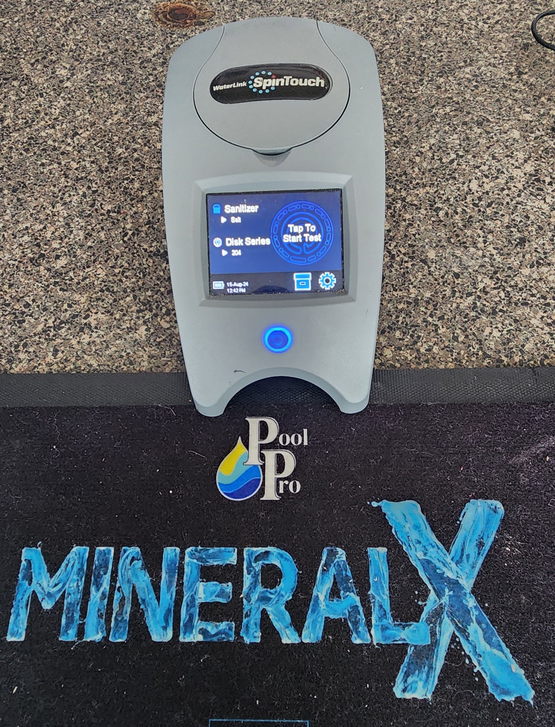 A Person Is Holding A Test Kit In Front Of A Swimming Pool — Kingscliff Pool Shop In Kingscliff, NSW