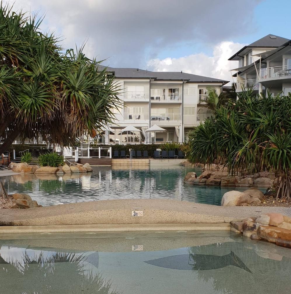 A Large Building With A Pool In Front Of It — Kingscliff Pool Shop In Kingscliff, NSW