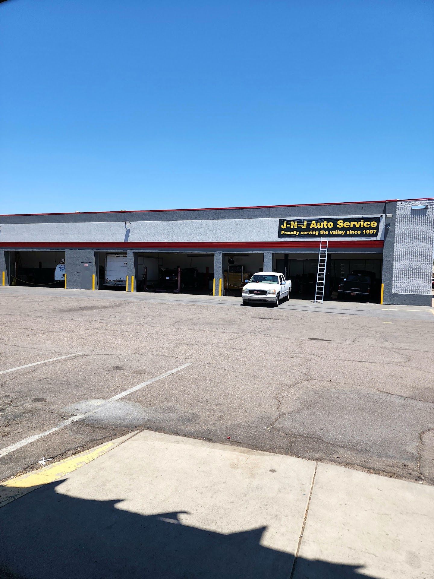 1960's Sedan Parked Outside Shop | J-N-J Auto Service