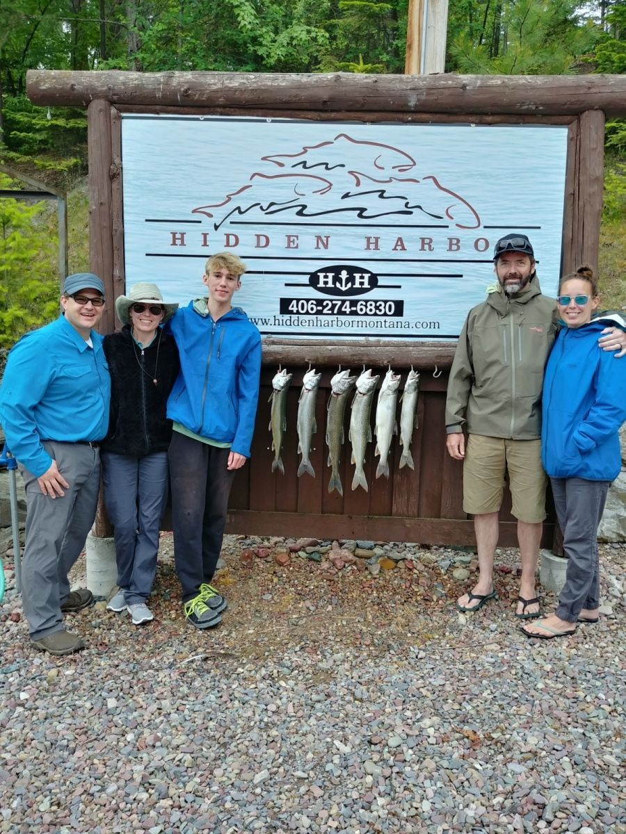 A group of people standing in front of a sign that says hidden harbor