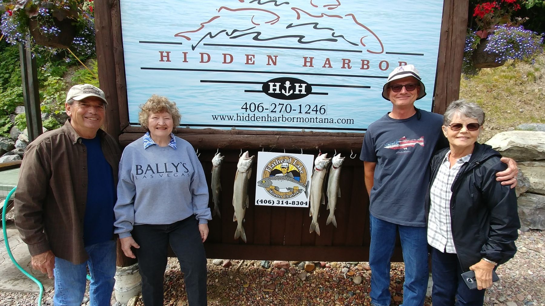 A group of people standing in front of a sign that says hidden harbor