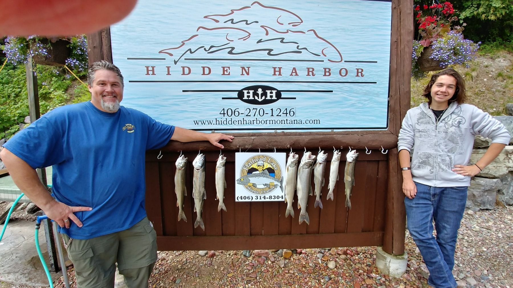 A man and a woman standing in front of a sign that says hidden harbor