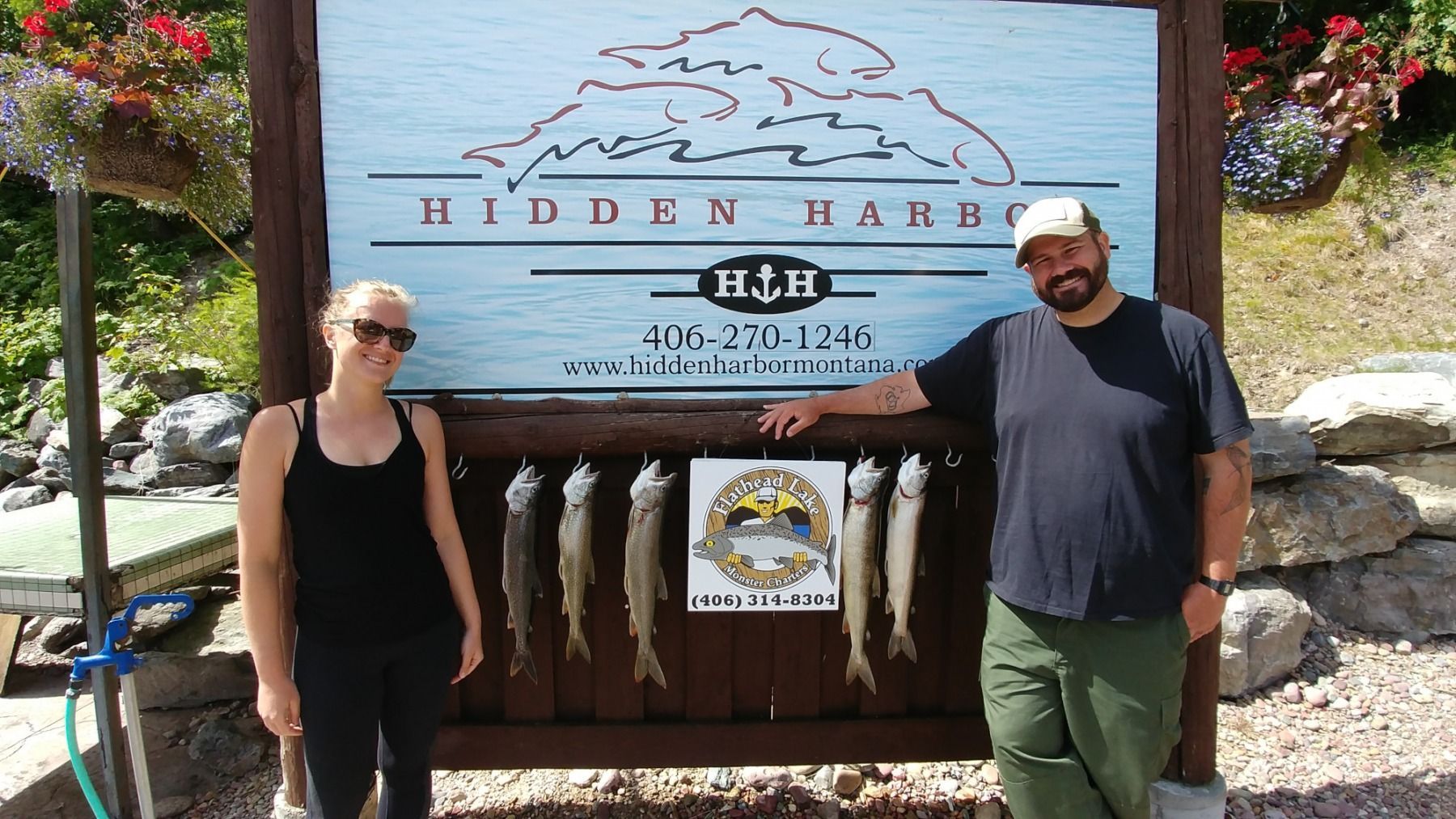 A man and a woman standing in front of a sign that says hidden park