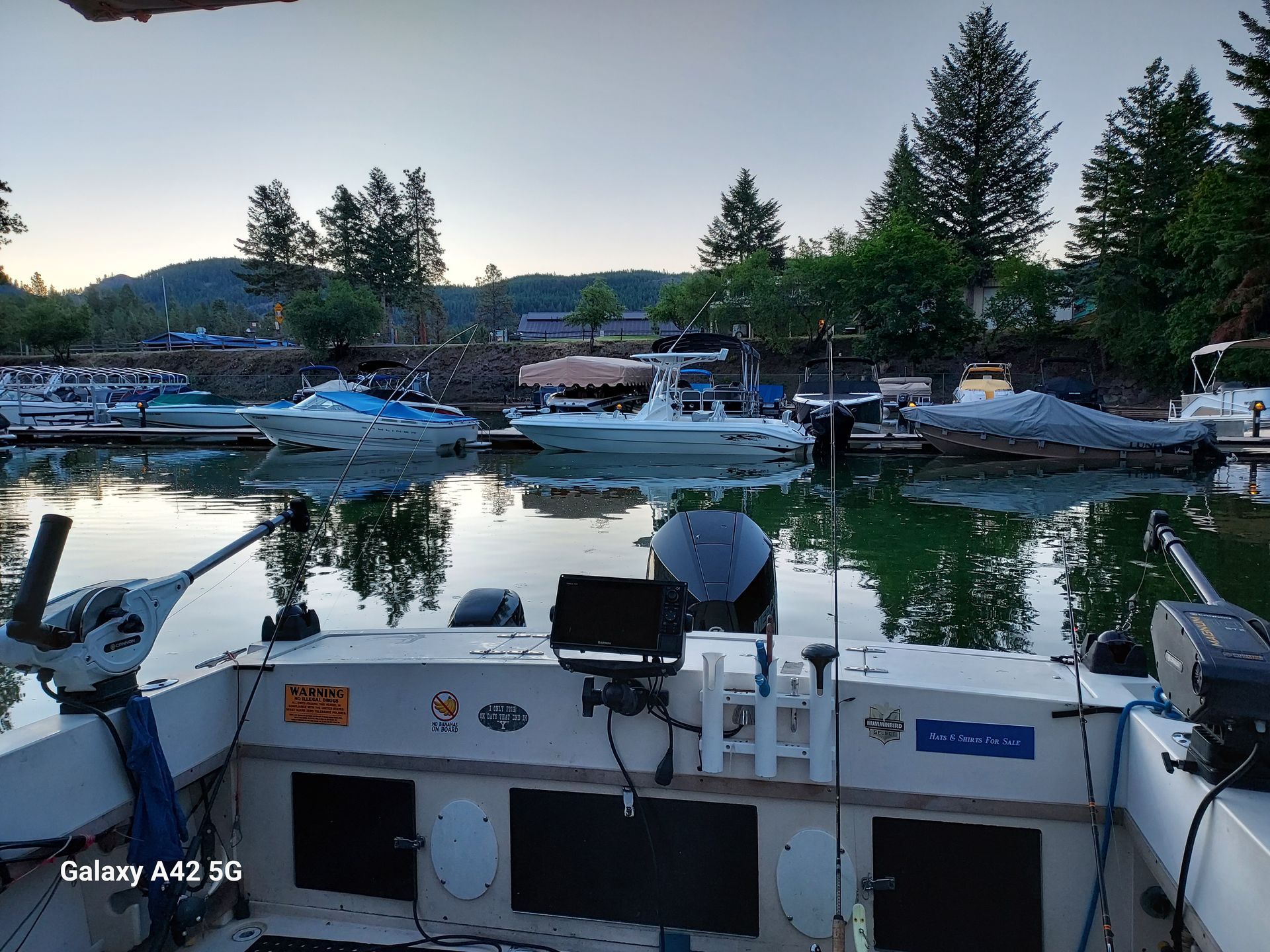 A boat is docked in a marina with other boats