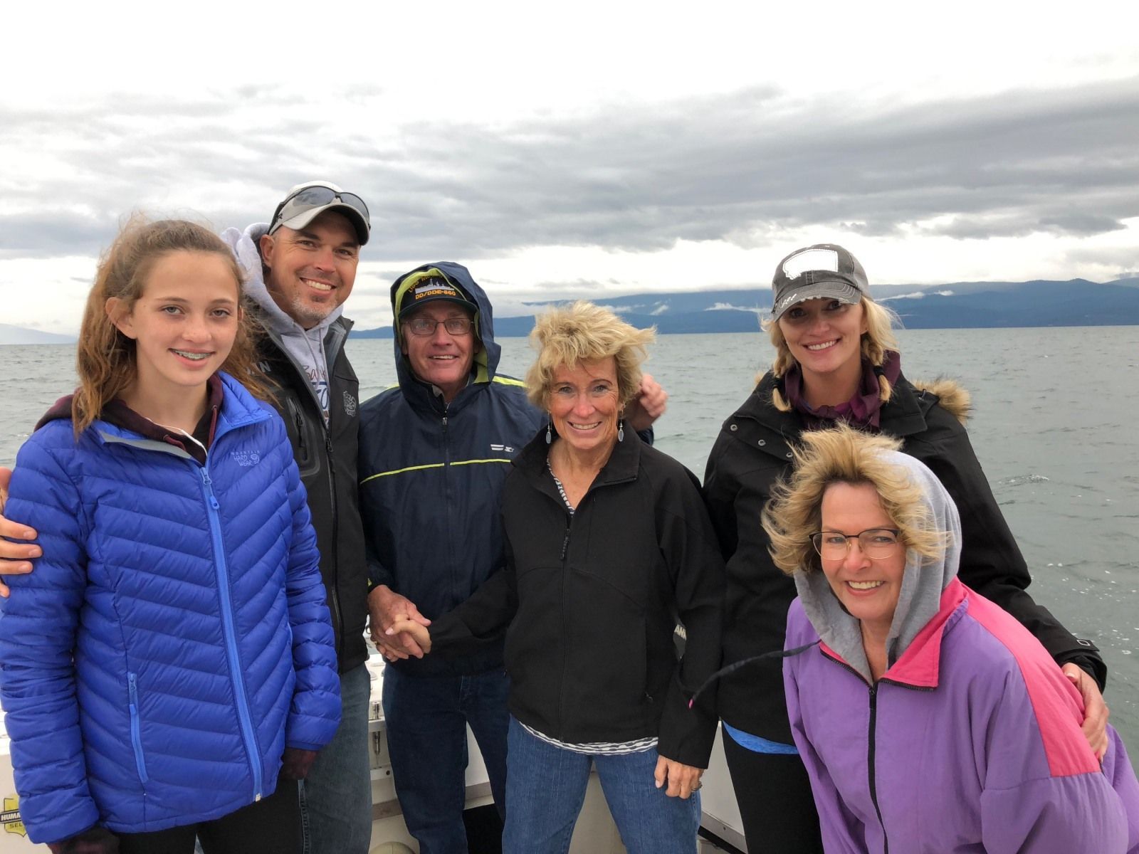 A group of people are posing for a picture on a boat.