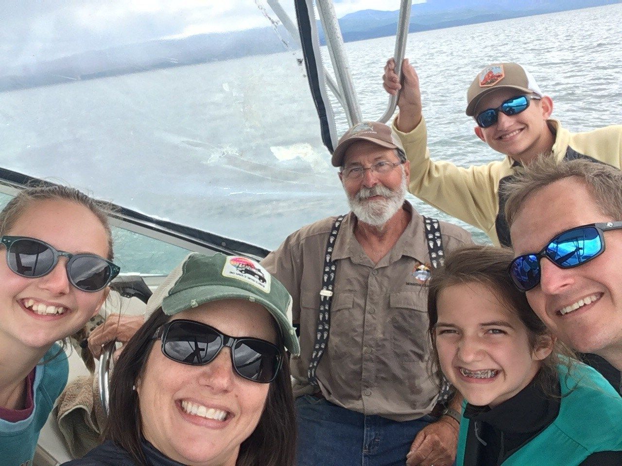 A group of people are posing for a picture on a boat.