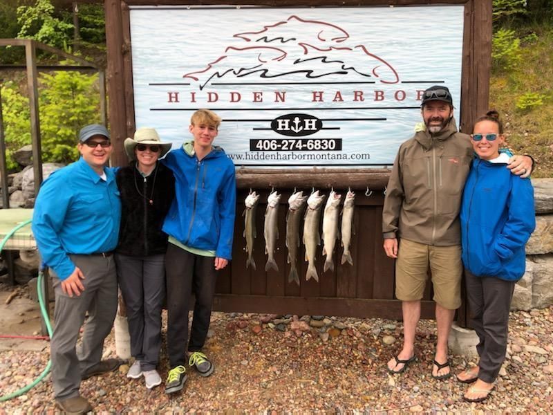 A group of people standing in front of a sign that says hidden harbor