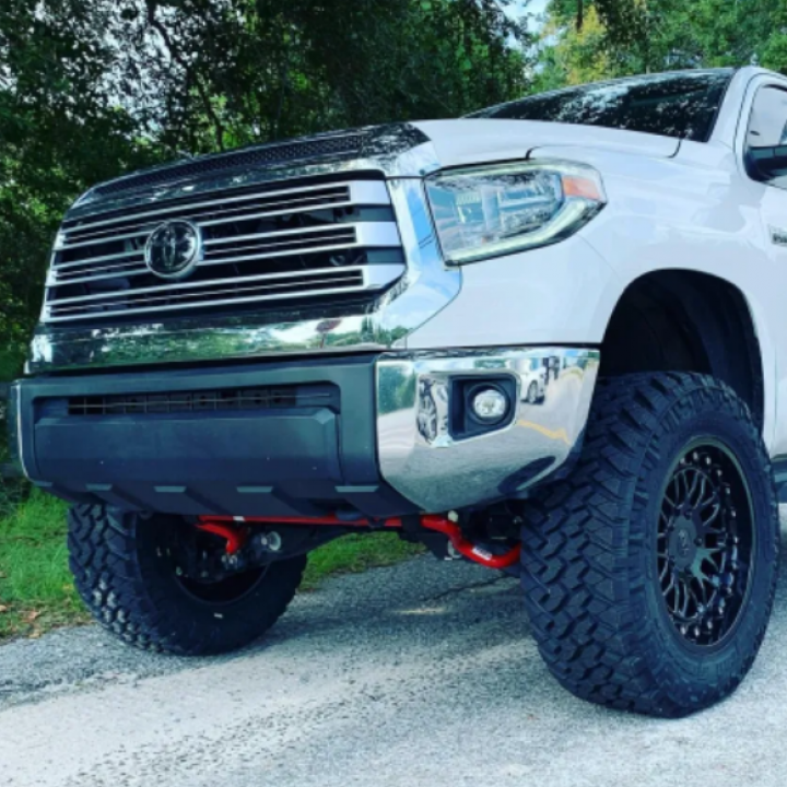 A white truck is parked on the side of the road