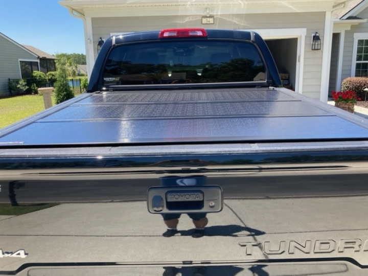 A tundra truck is parked in front of a house
