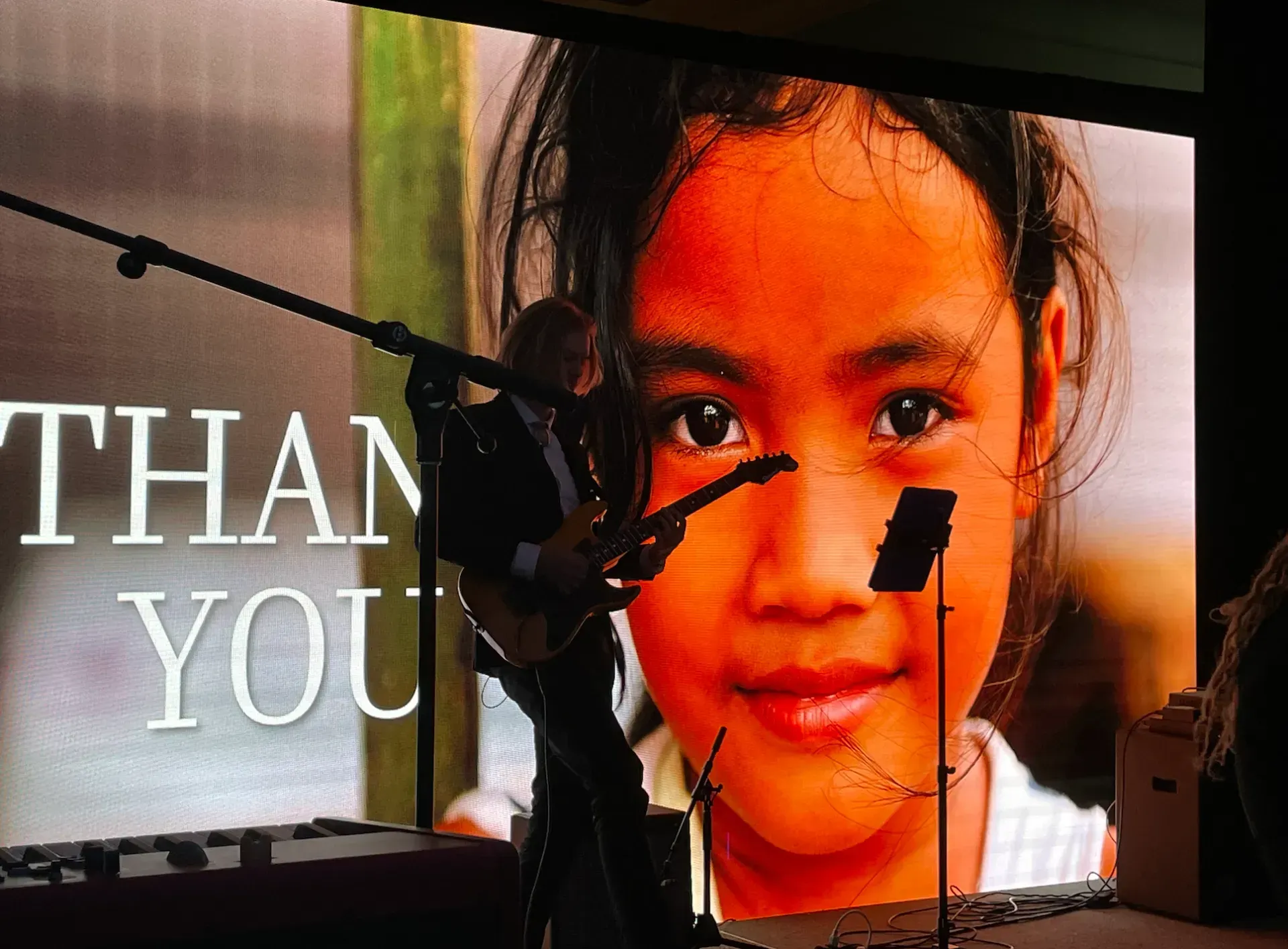 a large screen with a picture of a girl and the words thank you