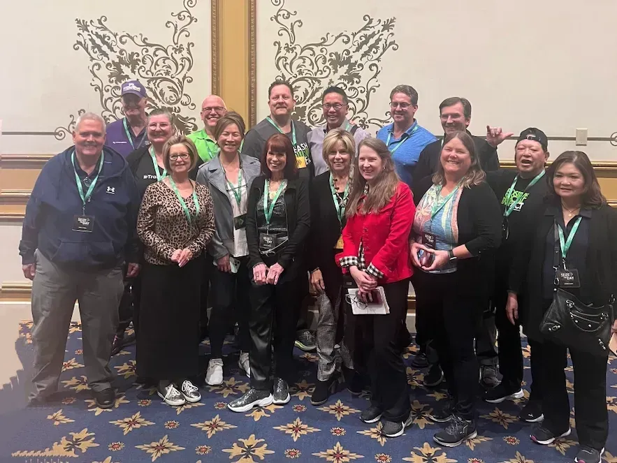 a group of people are posing for a picture in a room