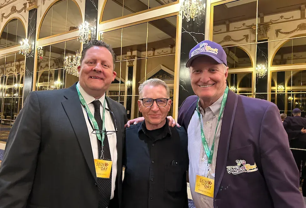 three men are posing for a picture together in a room