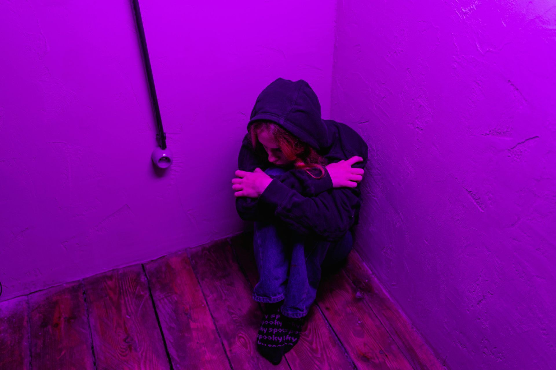 Young person sitting alone, representing isolation before finding pregnancy support