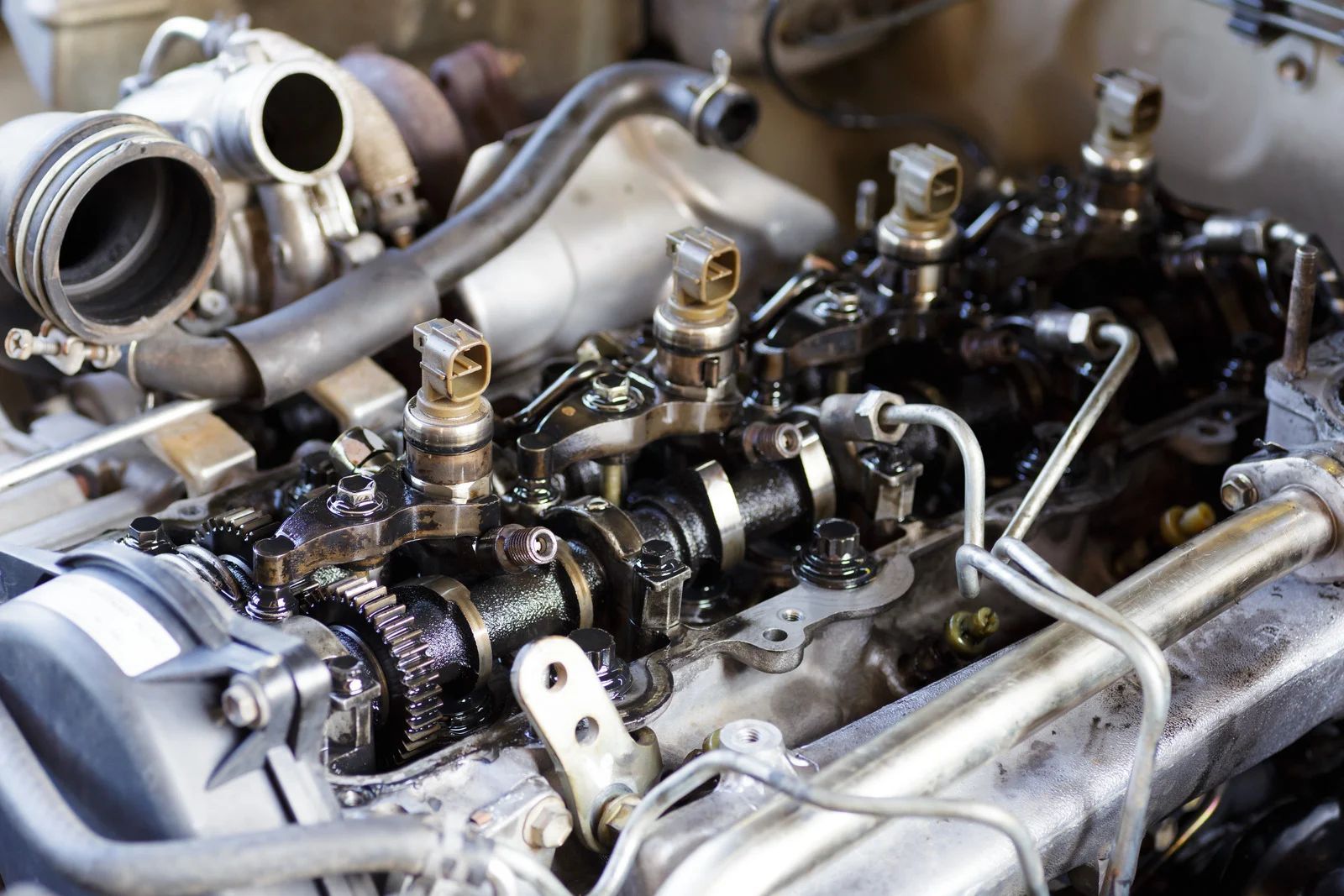 Dirty, open engine compartment with black oil visible.