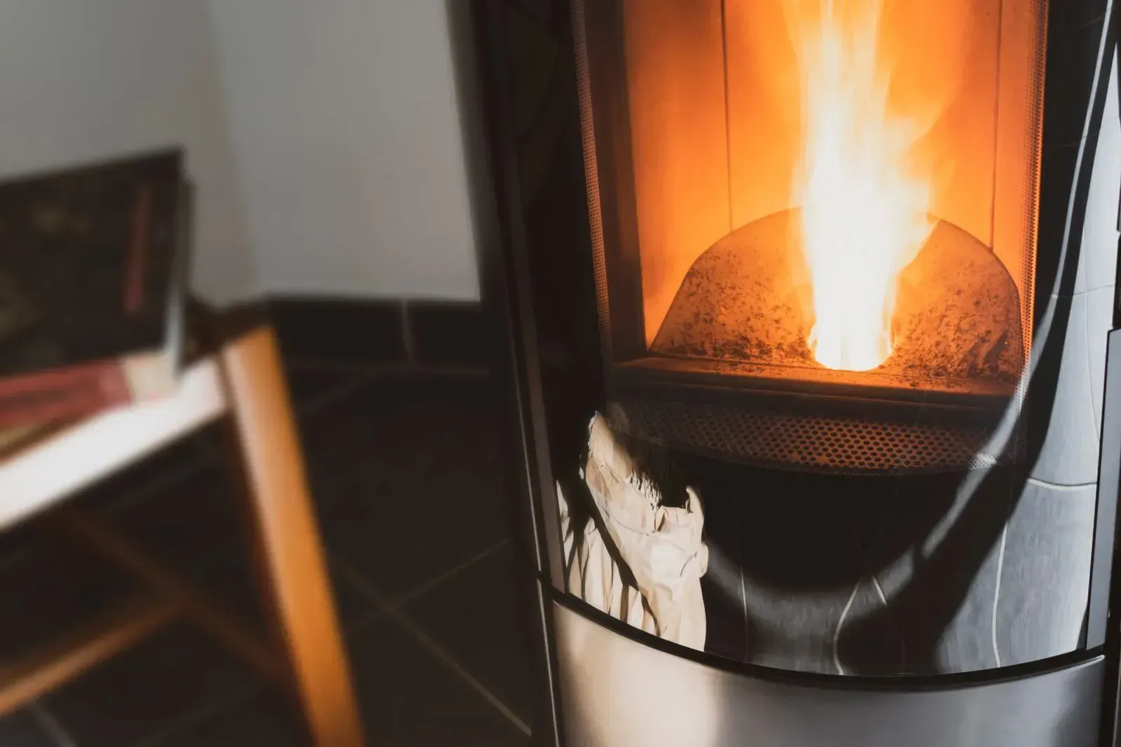 A close up of a stove with a fire coming out of it.