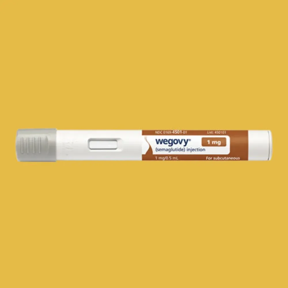 A pair of ear plugs are crossed over each other on a white surface.