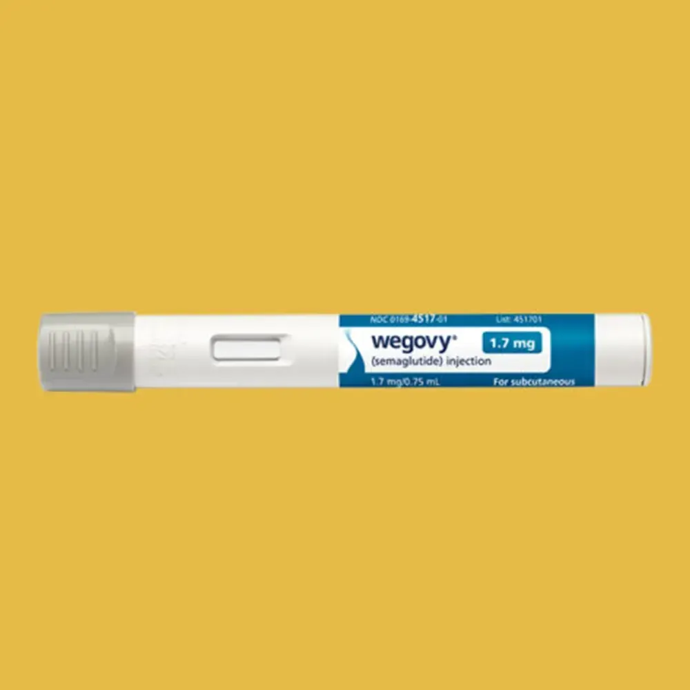 A pair of ear plugs are crossed over each other on a white surface.