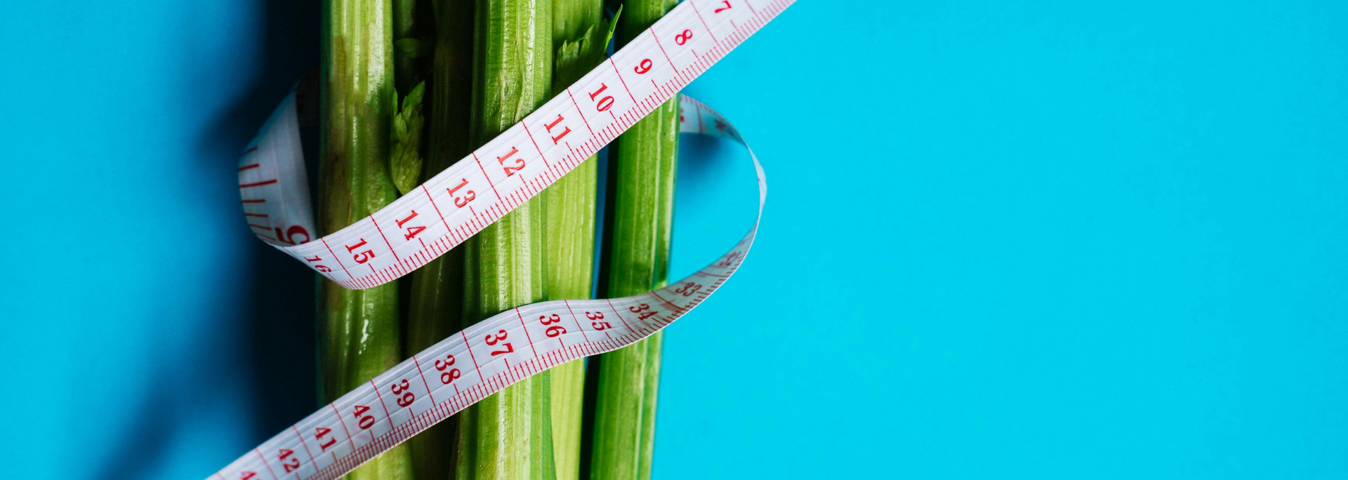 Picture of a measuring tape wrapped around celery. 