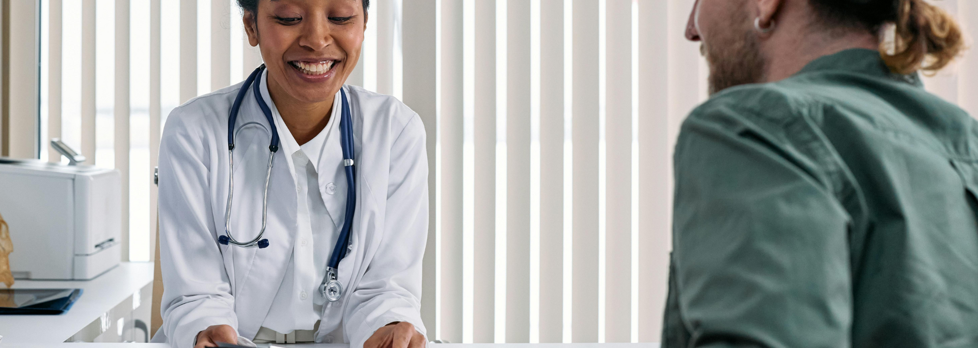 Picture of a friendly-looking doctor in consultation with a patient.