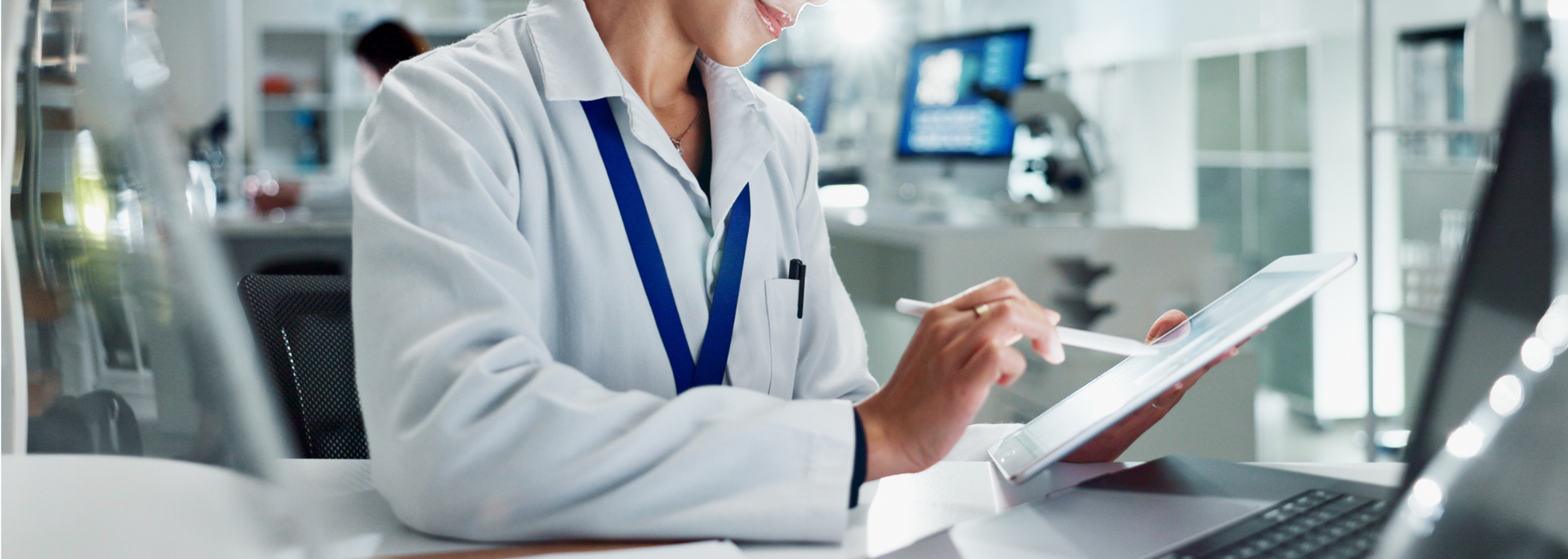 Picture of a medical scientist examining a report on a computer. Picture of a medical scientist examining a report on a computer.