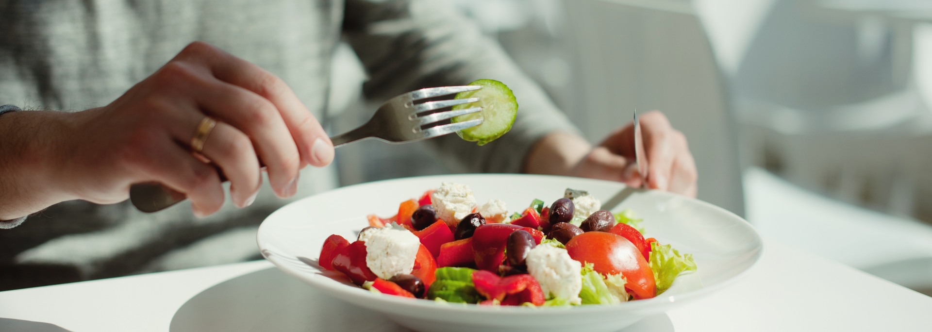Picture of a person eating a healthy plate of food. 