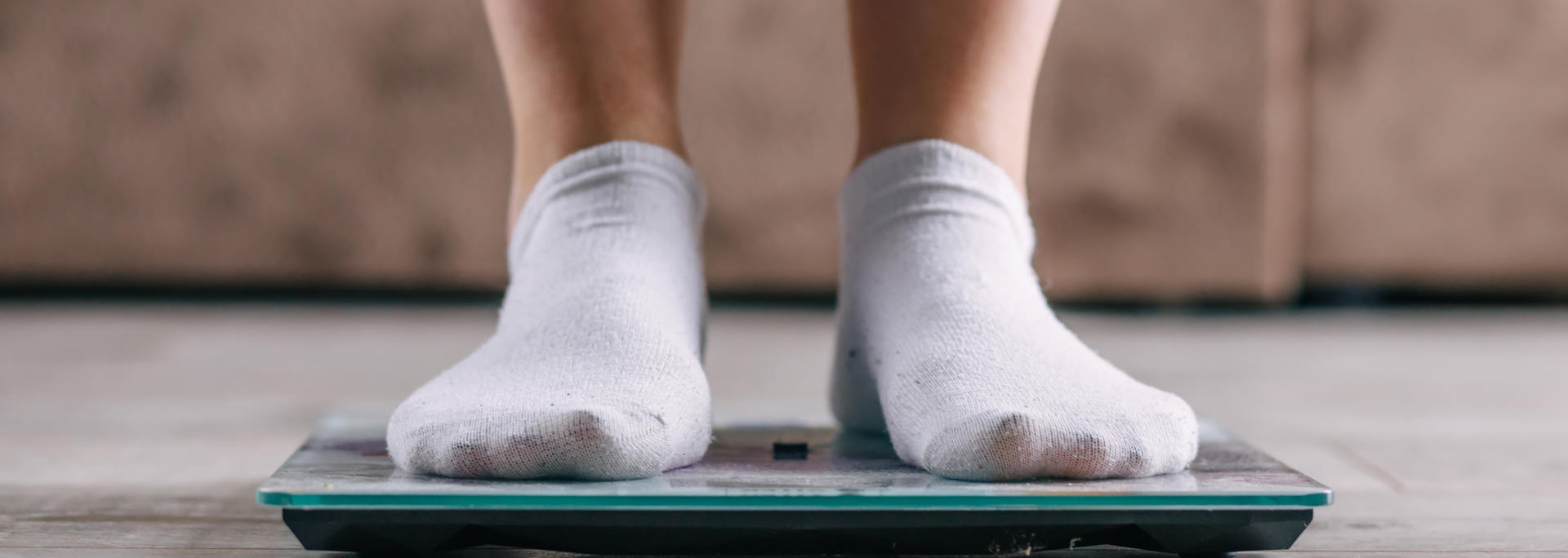 Picture of a person standing on scales. Picture of a person standing on scales.