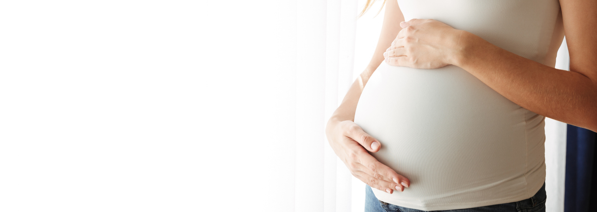 Picture of a woman cradling her pregnant belly. Picture of a woman cradling her pregnant belly.