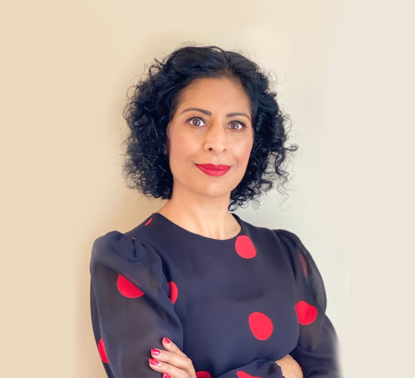 A woman in a black jacket is smiling for the camera.