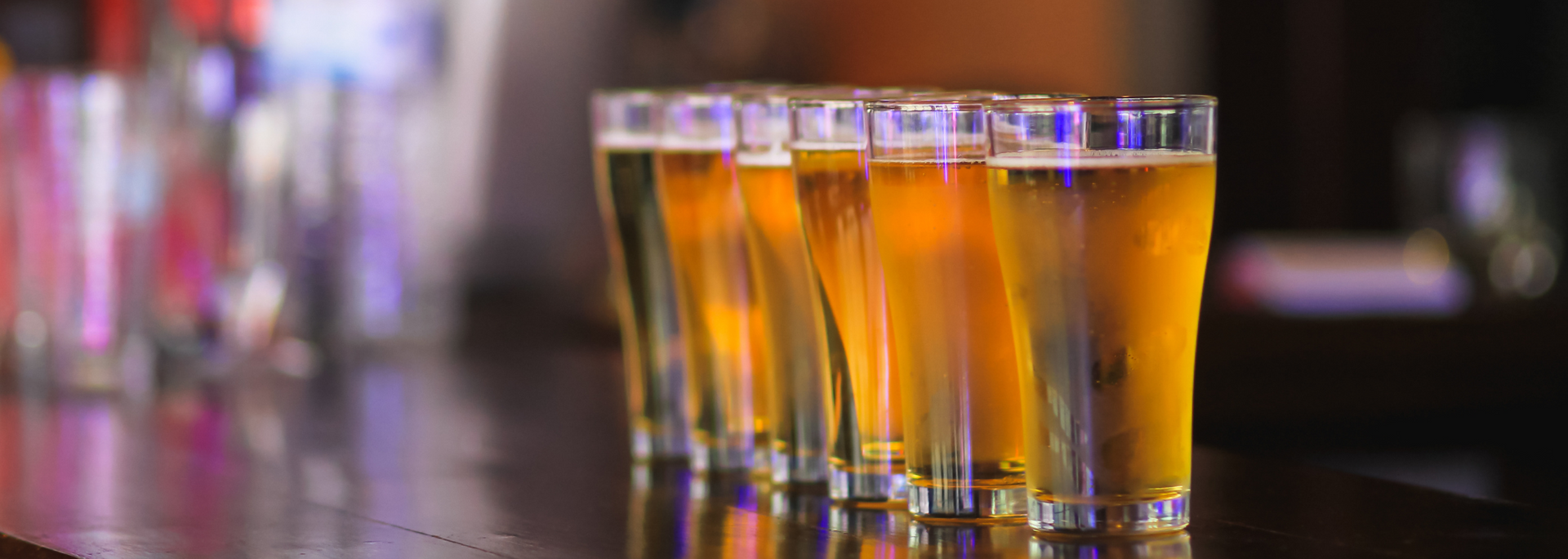 Picture of pints of beer on a bar.