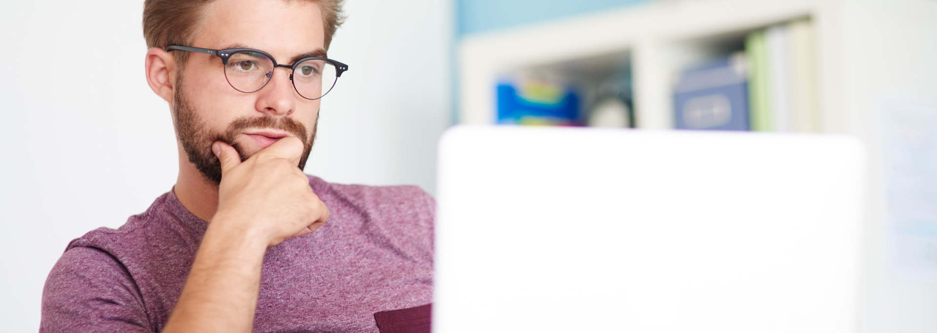 Picture of someone looking sceptical at a computer. Picture of someone looking sceptical at a computer.