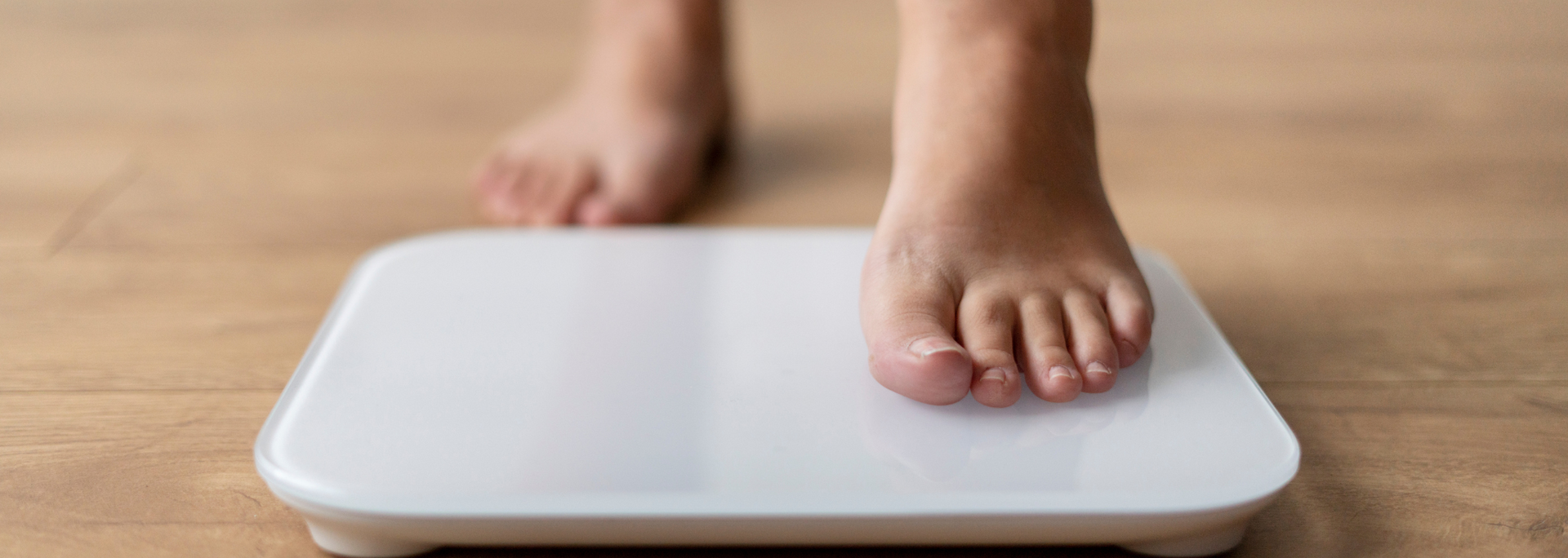 Picture of someone stepping on a scale.