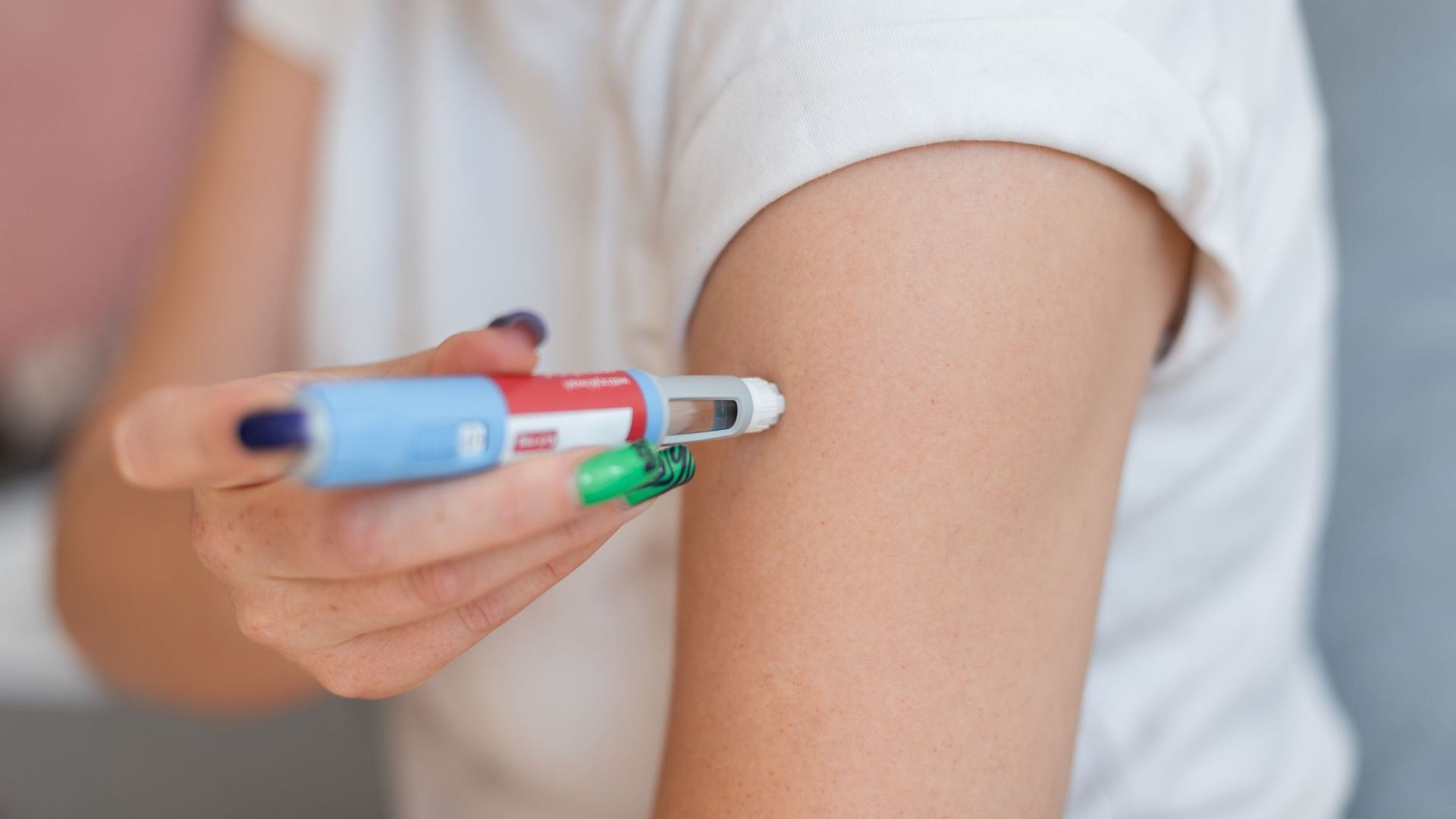 A woman is getting an injection in her arm.