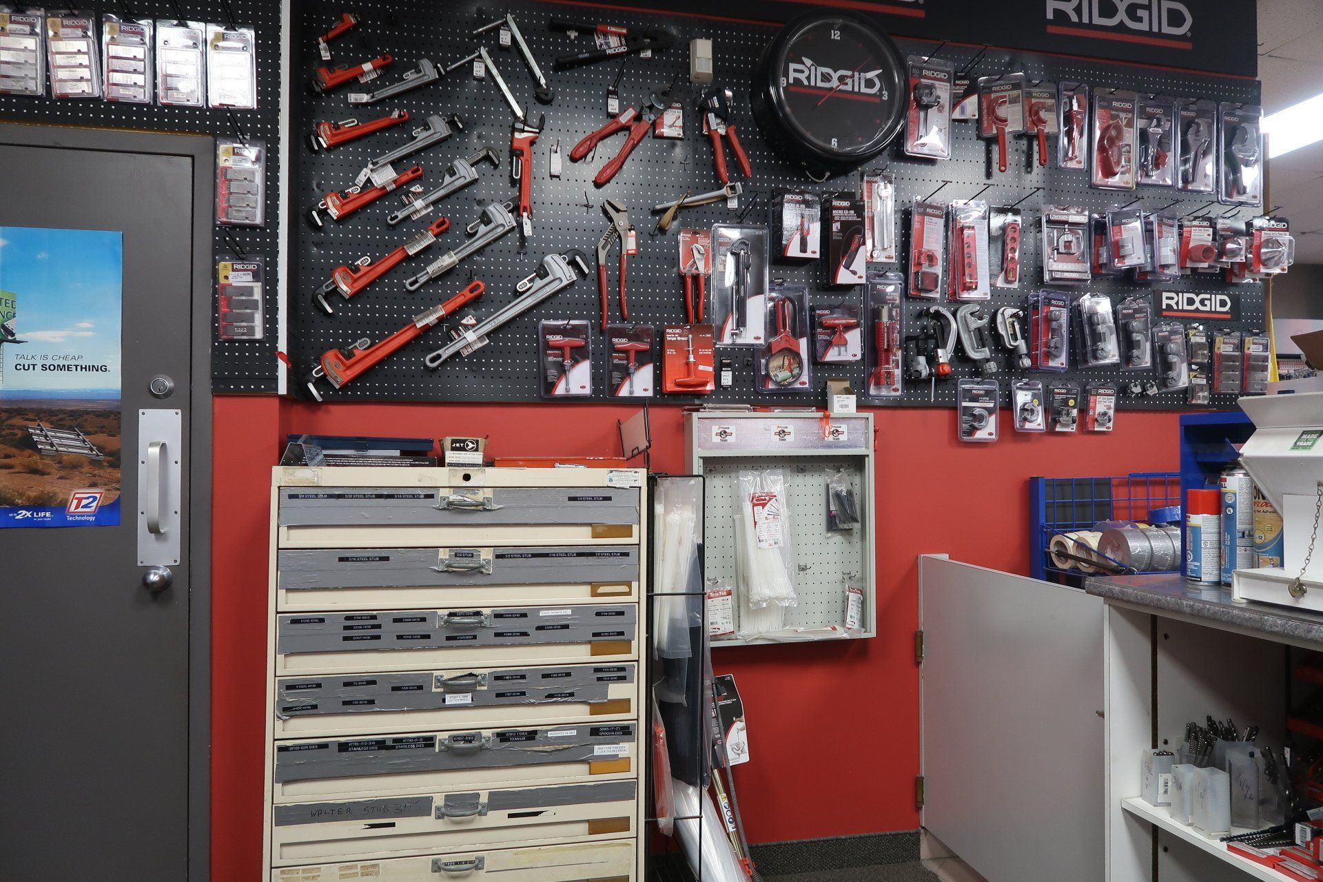 A room with a lot of tools on the wall and a dresser.