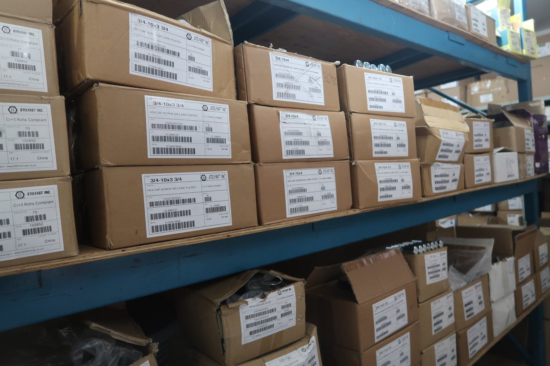 A warehouse filled with lots of boxes on shelves.