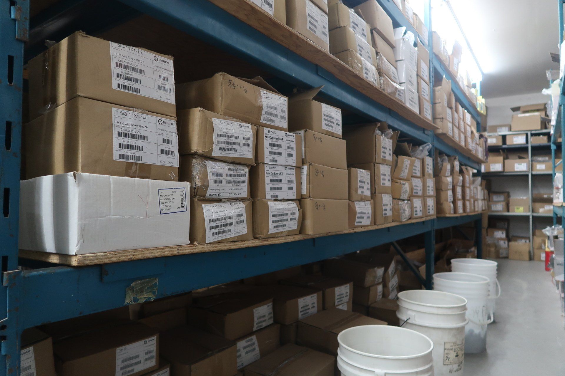 A warehouse filled with lots of boxes and buckets