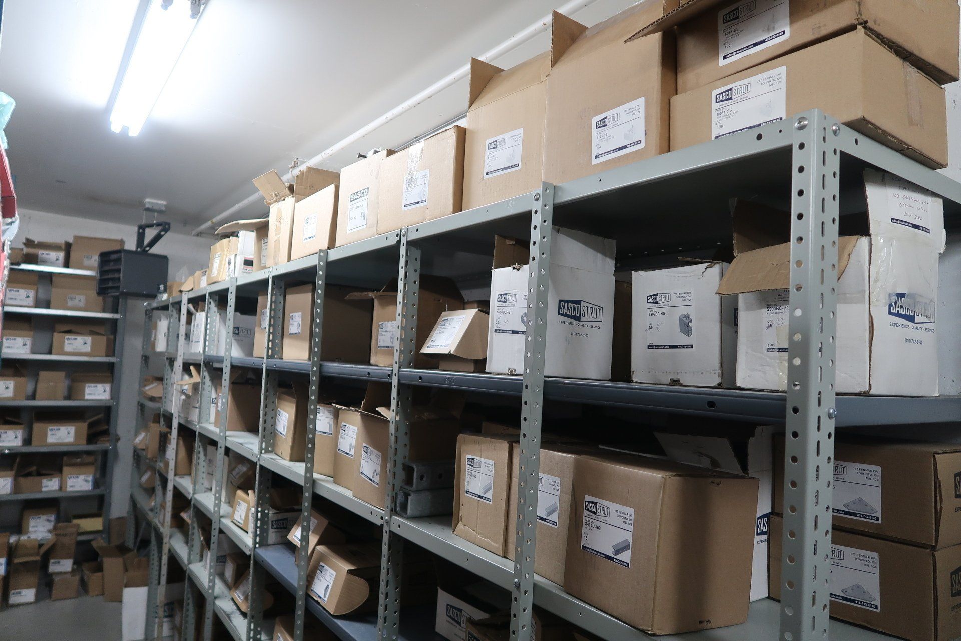 A warehouse filled with lots of boxes on shelves