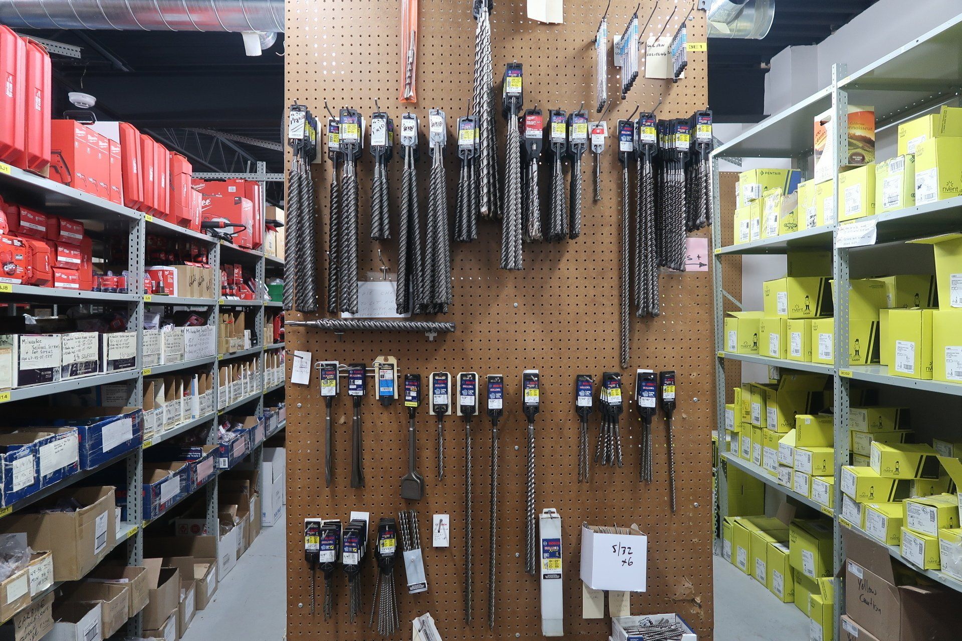 A bunch of tools are hanging on a wall in a store
