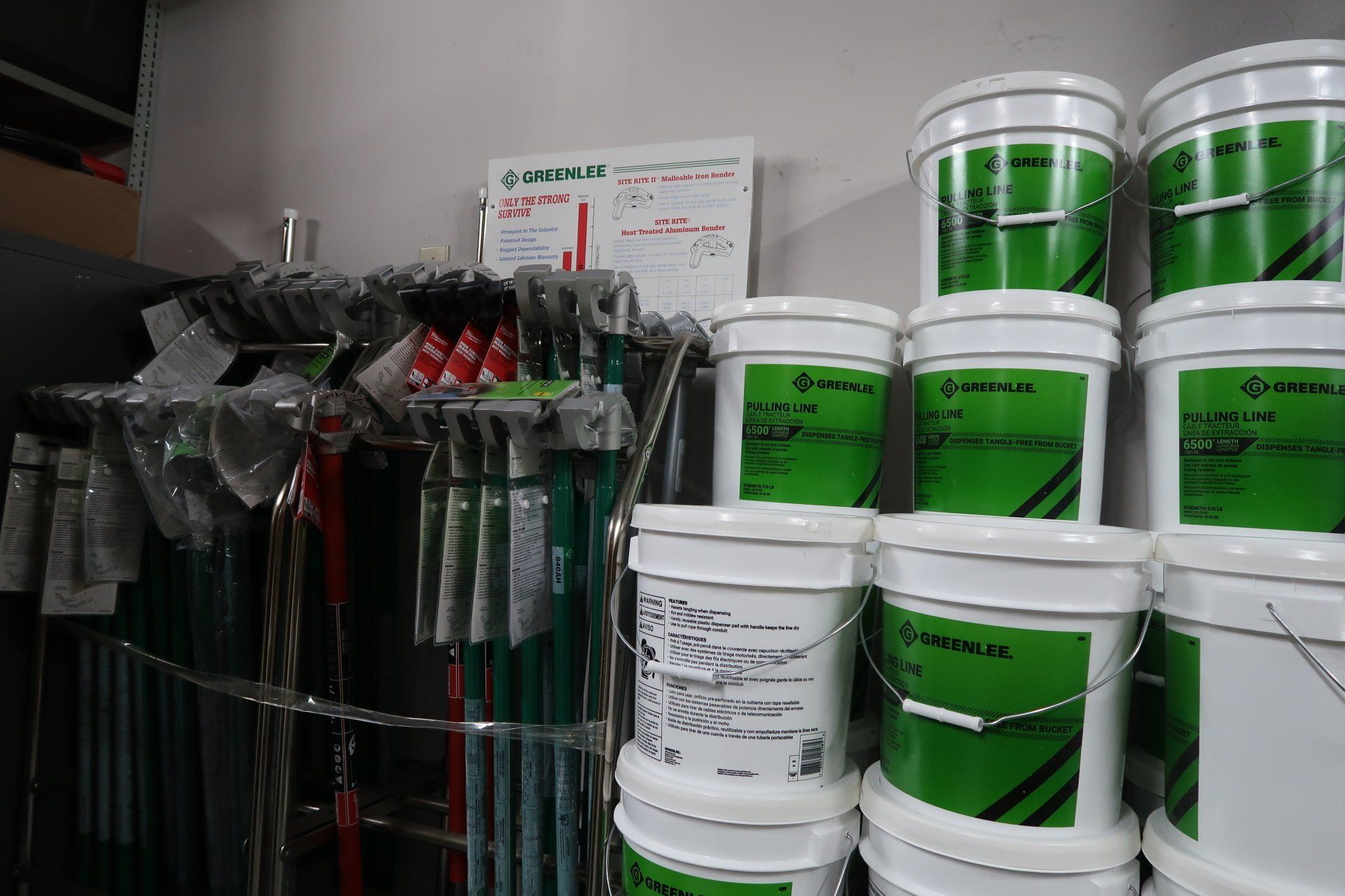 Buckets of paint are stacked on top of each other in a store.