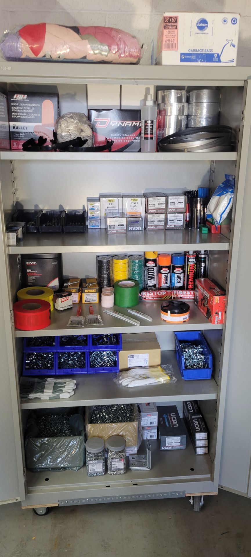 A cabinet filled with lots of tools and supplies.