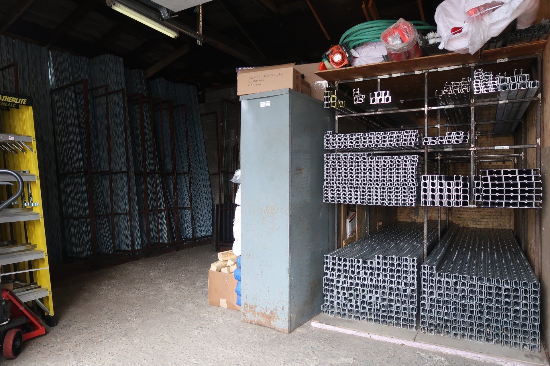 A storage room with a ladder and a bunch of boxes