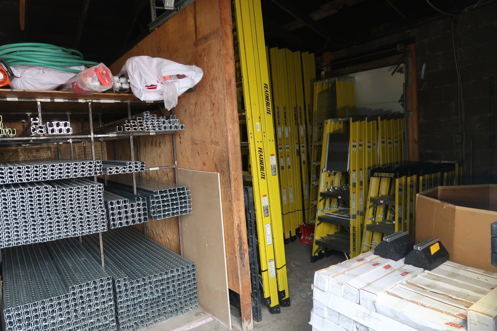 A warehouse filled with lots of yellow ladders