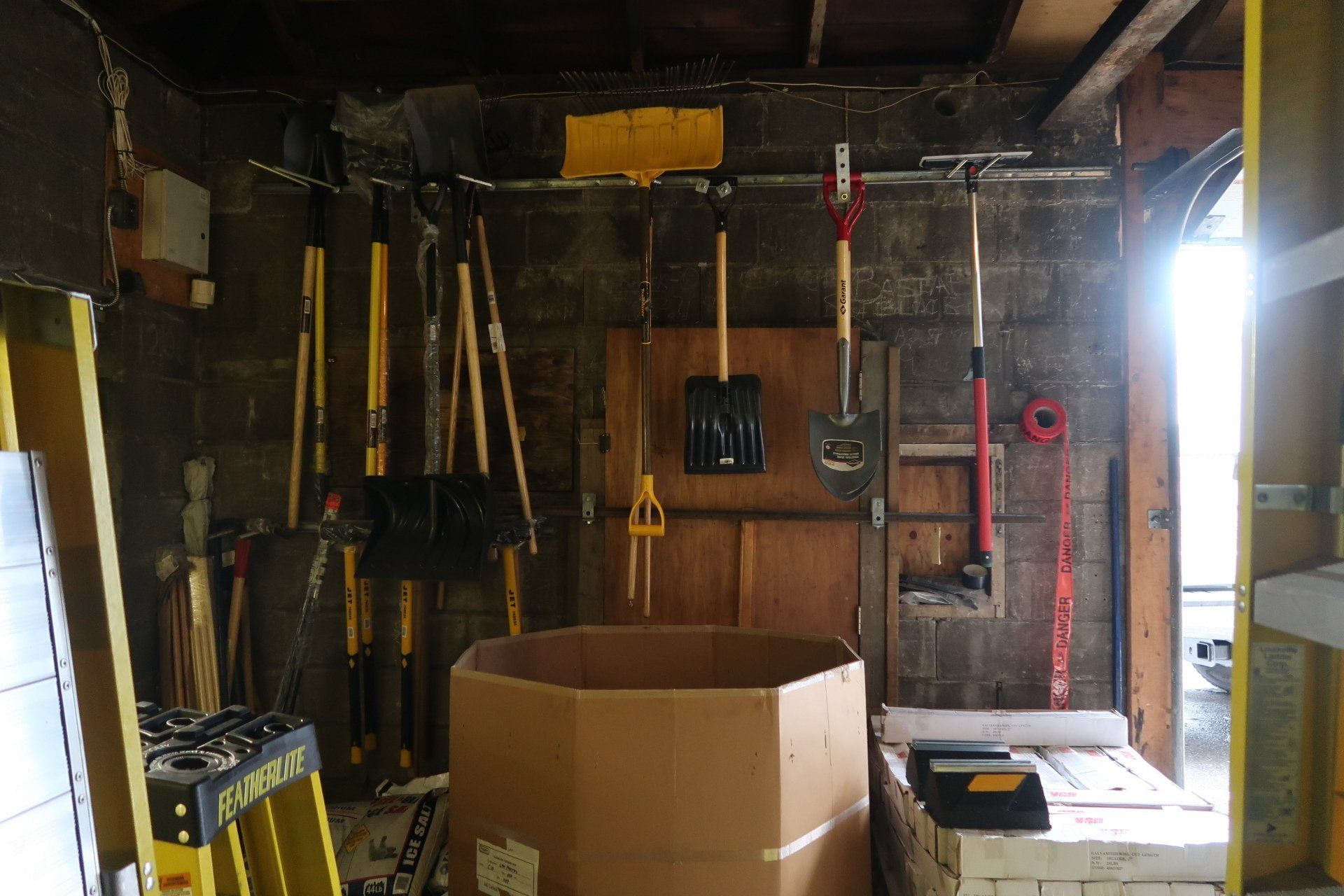 A garage filled with lots of tools including a ladder