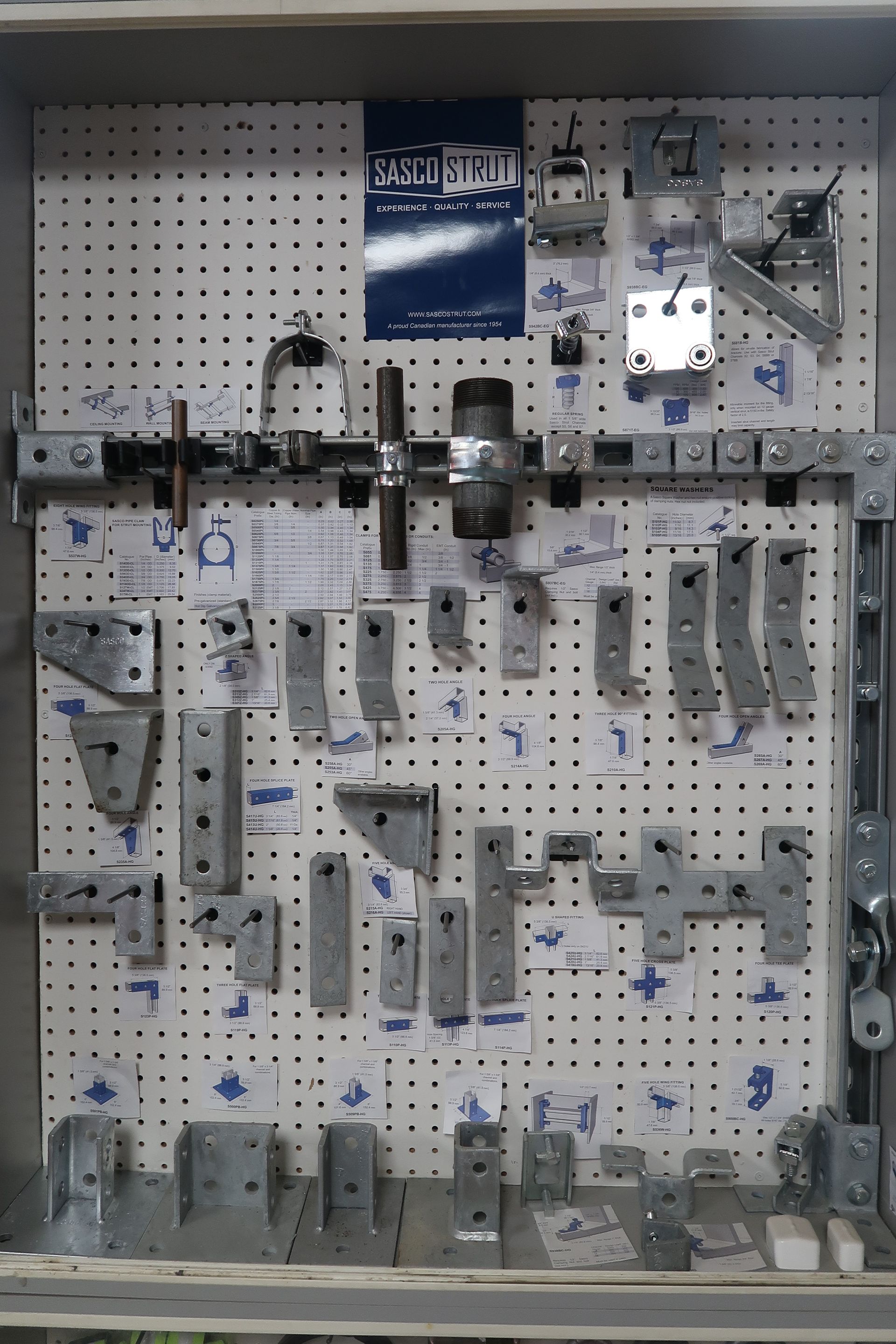 A wall with a bunch of metal parts on it