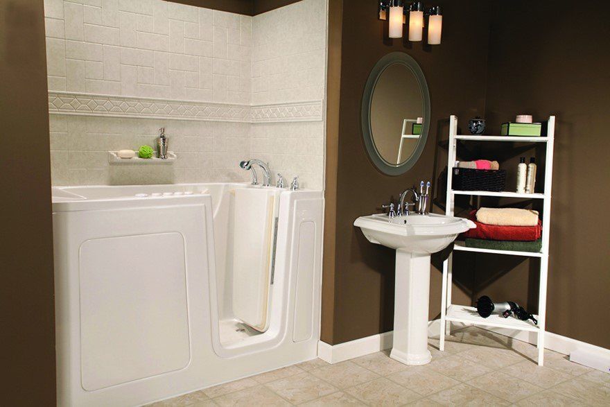 White walk-in tub with a curtain, next to a pedestal sink, shelf, and mirror in a bathroom with brown walls.