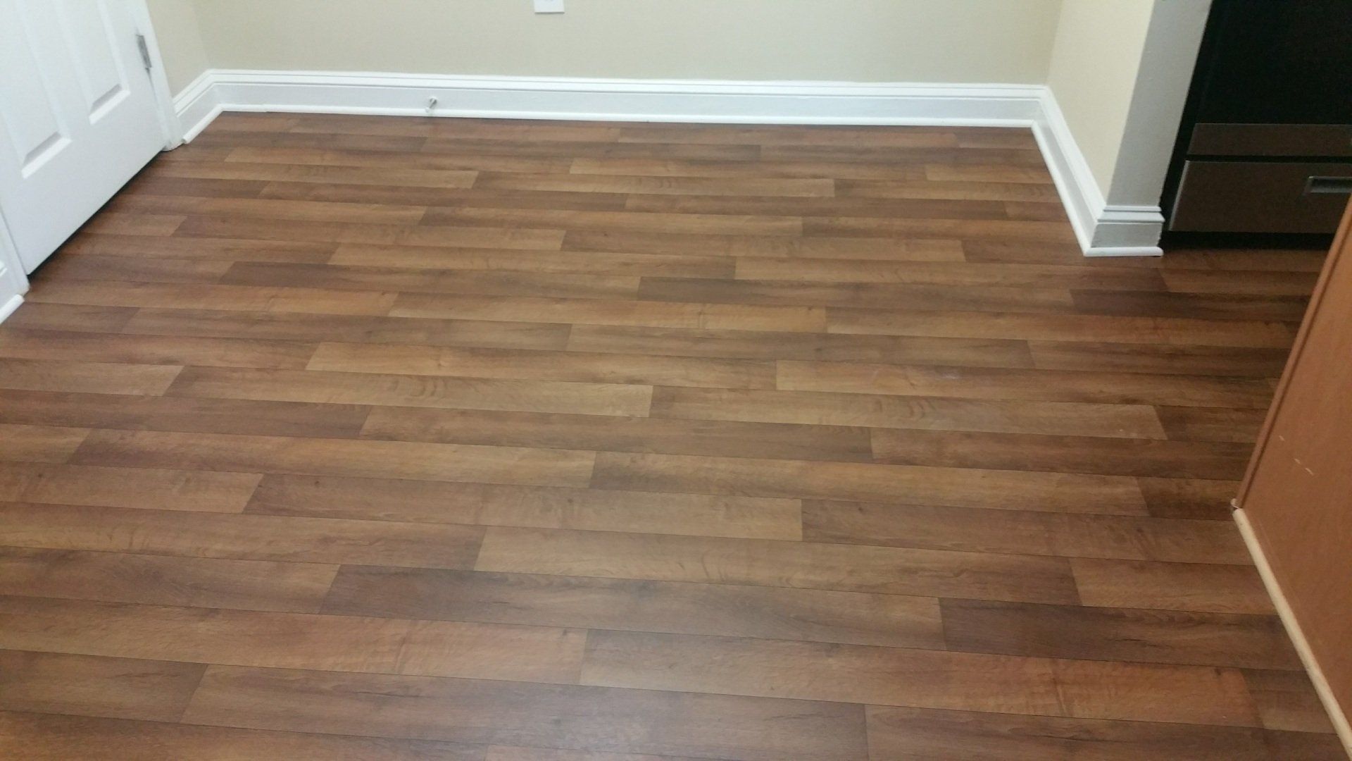 a room with a wooden floor and white trim