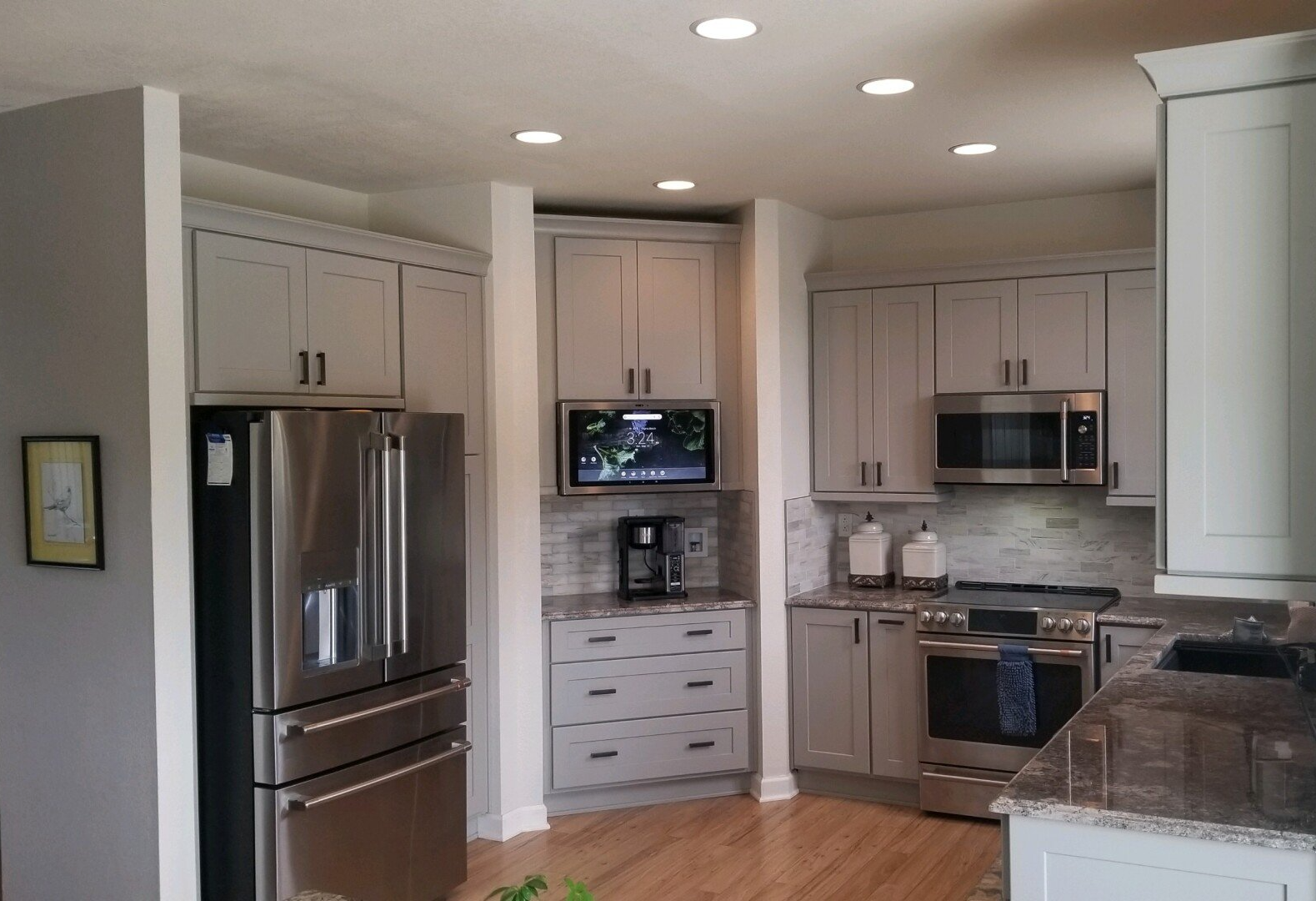 a kitchen with stainless steel appliances and white cabinets